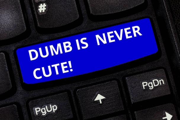 Text sign showing Dumb Is Never Cute. Conceptual photo To be stupid ignorant is never an attractive feature Keyboard key Intention to create computer message pressing keypad idea. - Photo, Image