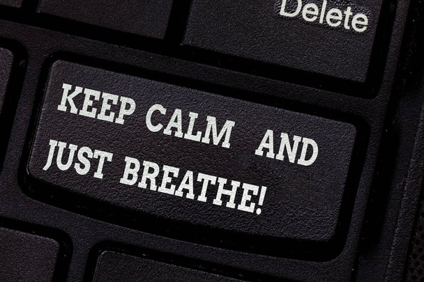 Writing note showing Keep Calm And Just Breathe. Business photo showcasing Take a break to overcome everyday difficulties Keyboard key Intention to create computer message pressing keypad idea. - Photo, Image