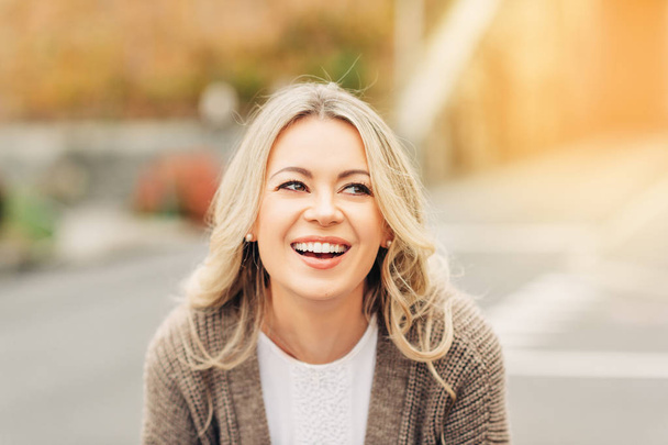 Portrait extérieur d'une femme souriante heureuse aux cheveux blonds
 - Photo, image