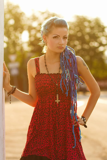  Stylish punk with piercing and different colored eyes posing outdoors - Zdjęcie, obraz