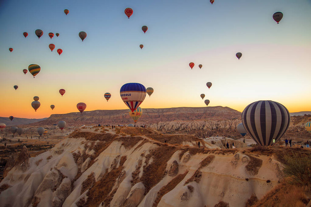 Central Anatolia, Goreme, Turkey - September 22, 2018. Amazing sunrise over Cappadocia. Colorful hot air balloons.  - Photo, image