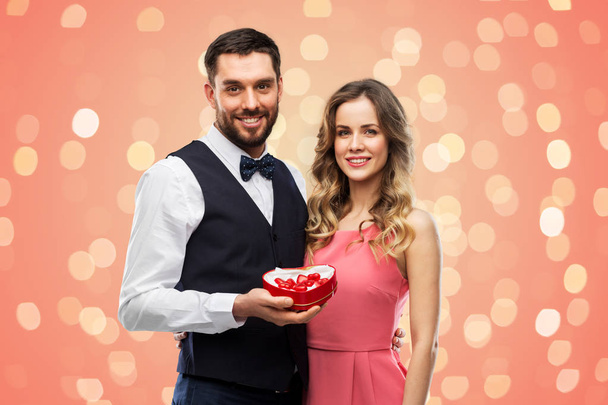happy couple with chocolate box in shape of heart - Foto, Imagem