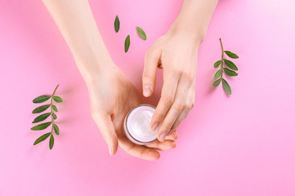 Moisturizing care skincare face cream for healing complicated troubled skin type in an open jar with visible texture. Copy space, close up, background, flat lay, top view. Eucalyptus leaf decoration. - Fotografie, Obrázek