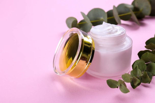 Moisturizing care skincare face cream for healing complicated troubled skin type in an open jar with visible texture. Copy space, close up, background, flat lay, top view. Eucalyptus leaf decoration. - Foto, Imagem