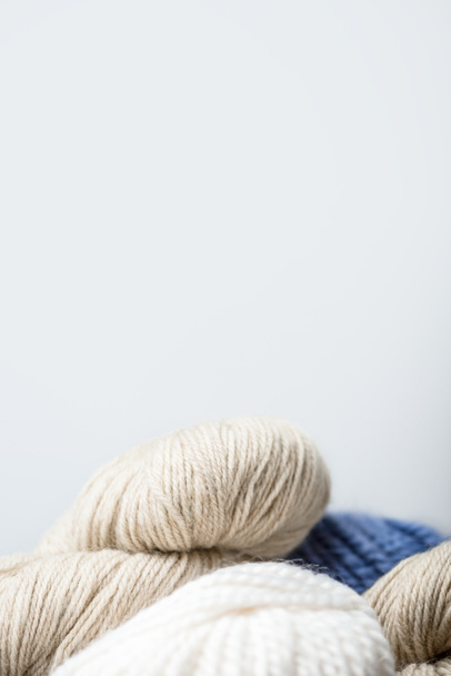 close up view of arranged knitting clews on grey backdrop - Zdjęcie, obraz