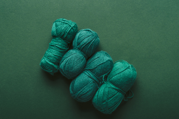 top view of green knitting clews on green background - Photo, Image