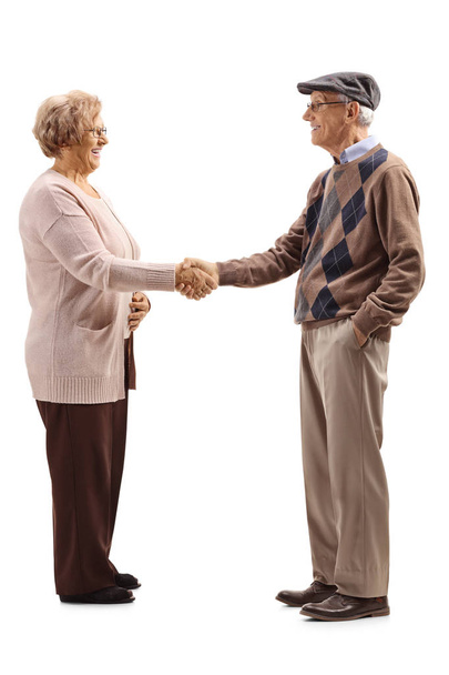 Full length shot of a senior man and woman shaking hands isolated on white background - Foto, Imagem