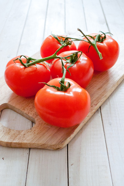 Fresh tomato on wooden board - 写真・画像