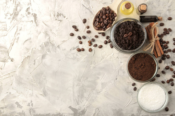 homemade coffee scrub in a jar for the face and body, and various ingredients for making scrub on a light background. spa. cosmetics. care cosmetics. top view with space for text - Foto, imagen