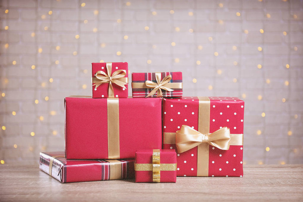 Christmas preparation concept. Stack of different colorful presents for every family member. Pile of gifts in bright festive wrapping. Close up, copy space grunged concrete wall background. - Photo, image