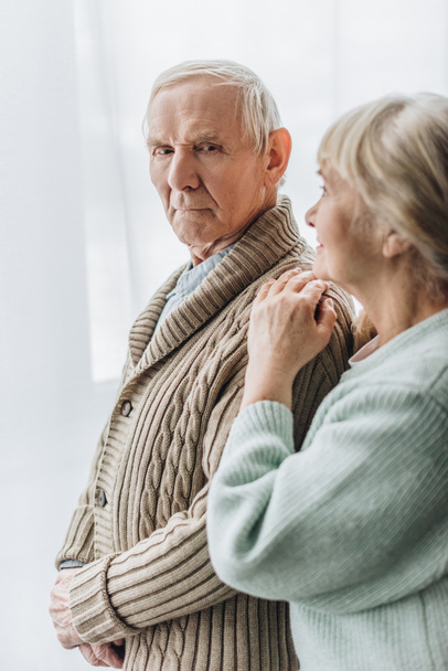 Seniorin schaut Rentner an und steht zu Hause - Foto, Bild