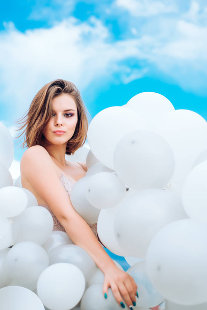 girl in sky. woman with naked body in party balloons. inspiration imagination. feeling freedom and dreaming. Fashion portrait of woman. pure beauty. summer style. better life. life in heaven - Photo, Image