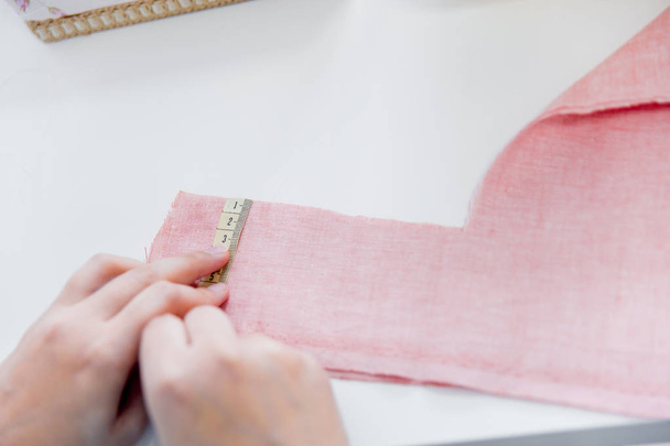 female hands are using a sewing machine - Фото, изображение