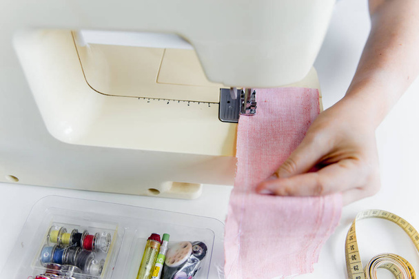 female hands are using a sewing machine - Foto, imagen
