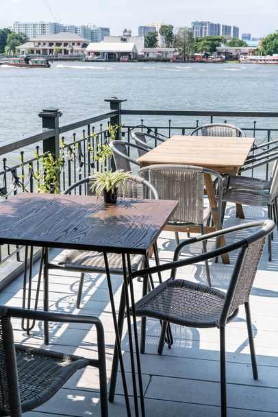 empty outdoor patio table and chair in restaurant and coffee shop - Photo, image
