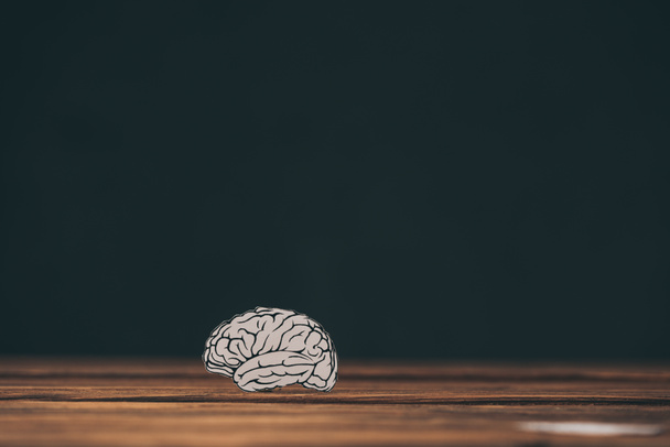 paper with brain shape as dementia symbol on black background  - Φωτογραφία, εικόνα