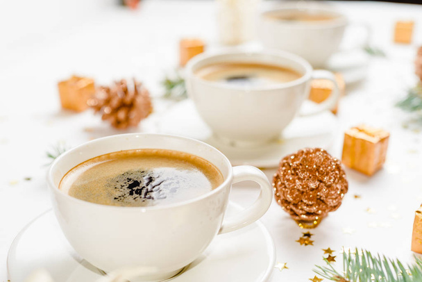 Creative natural layout of Christmas decorations with cups of coffee on a white background. - Photo, Image