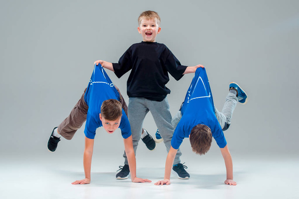 The kids dance school, ballet, hiphop, street, funky and modern dancers on gray studio background - Photo, Image