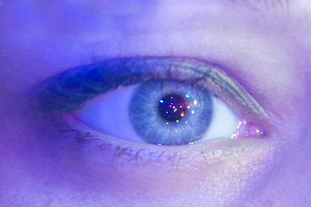 Female eye close up with a reflection of the lights in it - 写真・画像