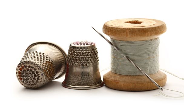 Sewing thimbles, bobbin and needle - Photo, Image