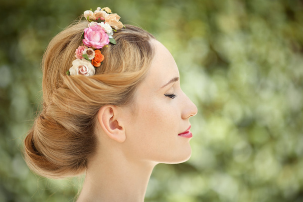 Beautiful young woman with flowers wreath in hair on natural gre - Fotografie, Obrázek