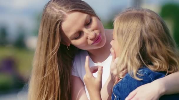 Young mother and little daughter outdoors - Materiał filmowy, wideo