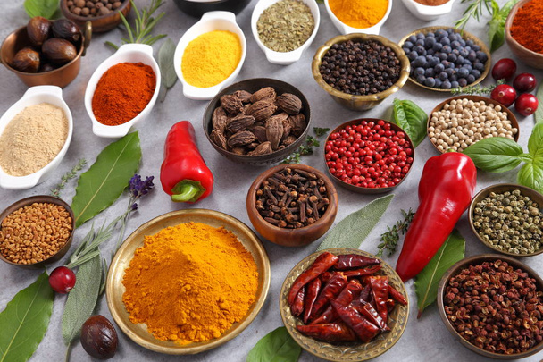 Colorful, aromatic spices and fresh herbs on a light background. Top view. - Foto, imagen