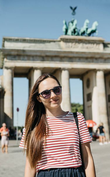 Portrait of a young beautiful positive smiling stylish tourist girl. - 写真・画像