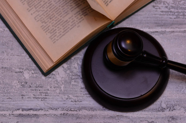 judge gavel beside pile of books on wooden background - Φωτογραφία, εικόνα