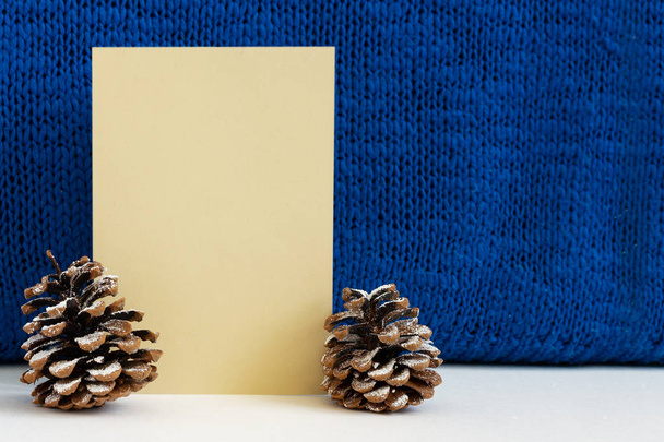 warm blue sweater, cones and paper for Christmas greetings - Photo, Image