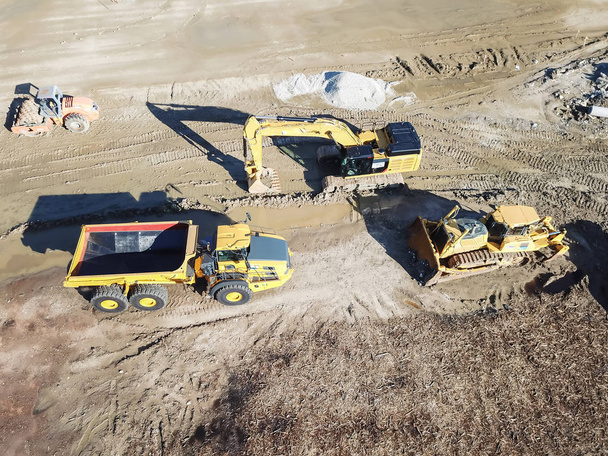 Máquinas de visão aérea e equipamentos pesados em grande canteiro de obras em Carrollton, Texas, EUA. Parte superior da escavadeira, escavadeira, caminhão basculante, escavador
 - Foto, Imagem