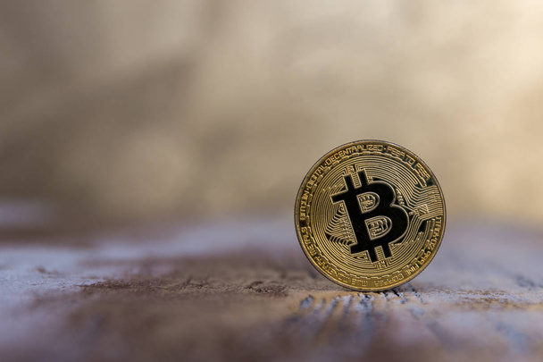  golden bitcoin stand on blurred background - Foto, imagen