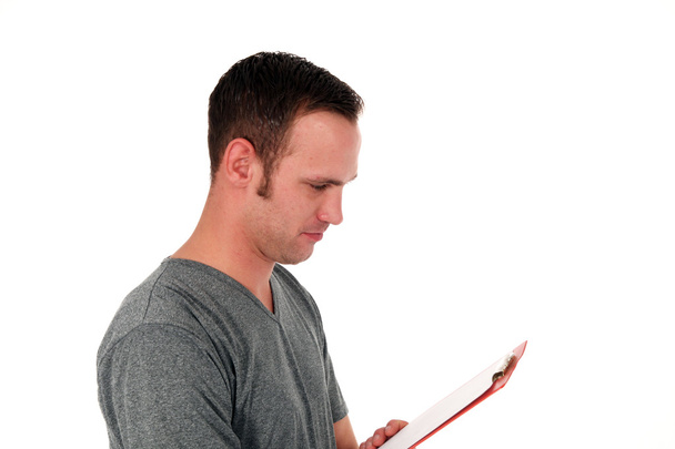Man reading notes on a clipboard - Photo, image