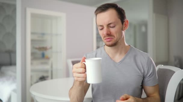 This cup of tea is bad or good. Man gesturing thumbs up and down. - Materiaali, video