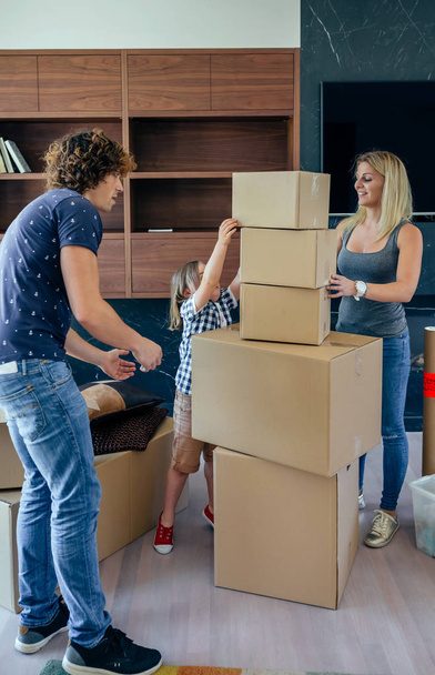 Parents with child helping to make move - Photo, Image