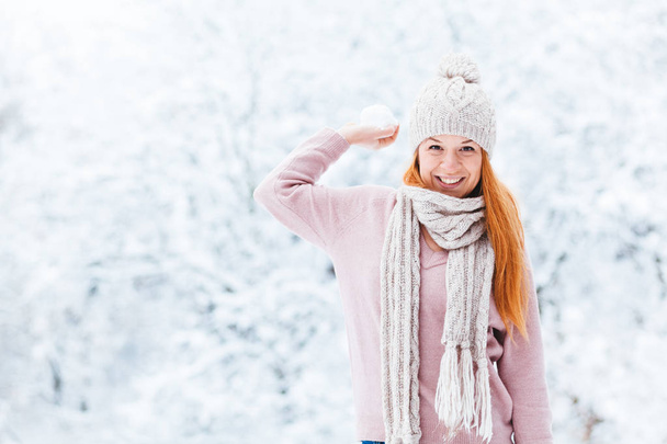 Young woman with snowball in the park - Photo, Image