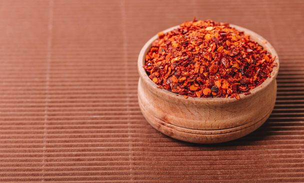 dry hot pepper in a bowl on brown background - Photo, Image