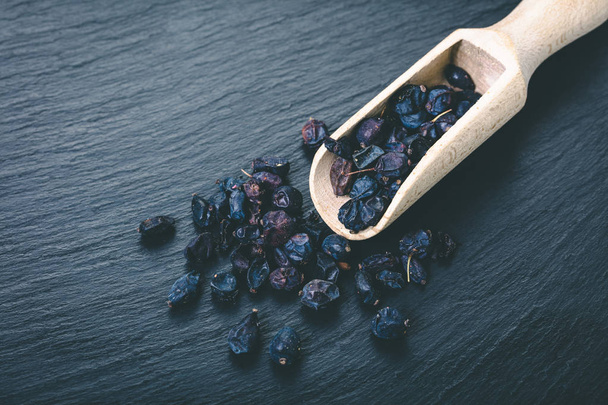spice dry barberry on black stone background - Фото, зображення