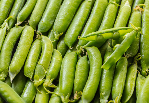 food background of a texture of green peas pods - Фото, зображення