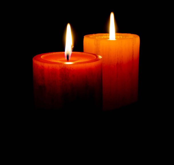 Red an orange candle before the dark with black background - Foto, Imagem