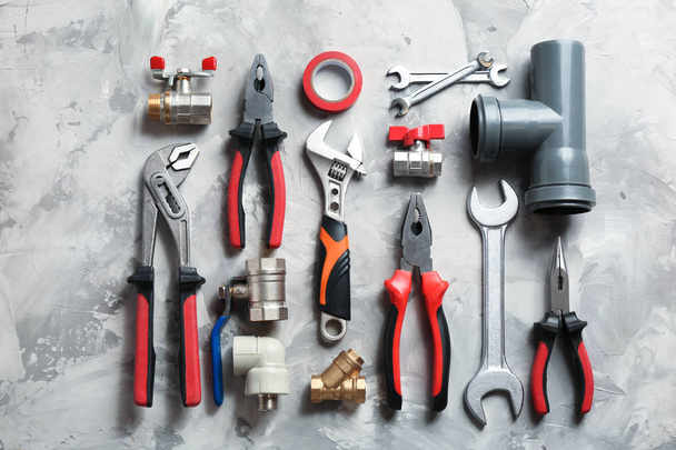 Flat lay composition with plumber's tools on grey background - Φωτογραφία, εικόνα