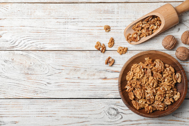 Flat lay composition with walnuts and space for text on wooden background - Foto, immagini
