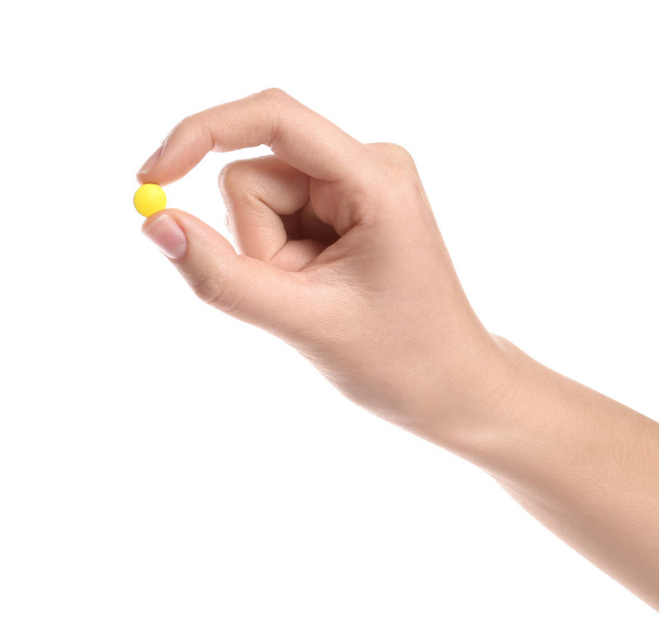 Woman holding color pill on white background, closeup - Zdjęcie, obraz