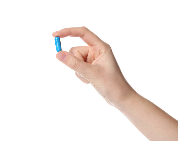 Woman holding color pill on white background, closeup - Φωτογραφία, εικόνα