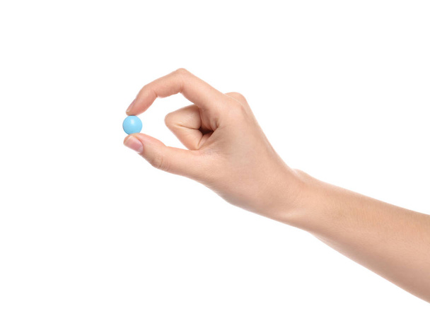 Woman holding color pill on white background, closeup - Foto, imagen
