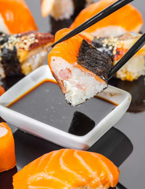 Japanese cuisine, sticks keep roll with salmon - Foto, Imagen