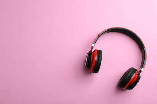 Wireless headphones on color background, top view. Space for text - Photo, Image