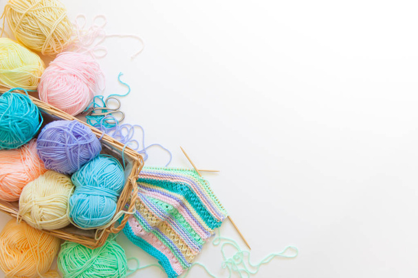 top view of colored yarn balls and knitting needles isolated on white - 写真・画像