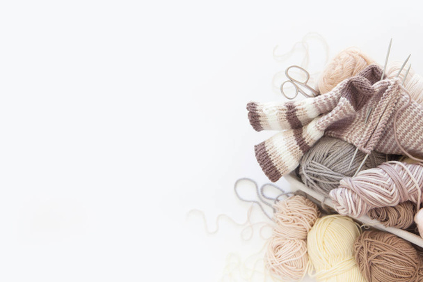 Yarn in a basket of beige and neutral, natural tones, knitting and crocheting. Spokes, succulent, scissors. White background. - Photo, image