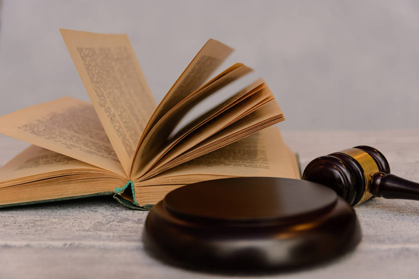 judge gavel beside pile of books on wooden background - Photo, image